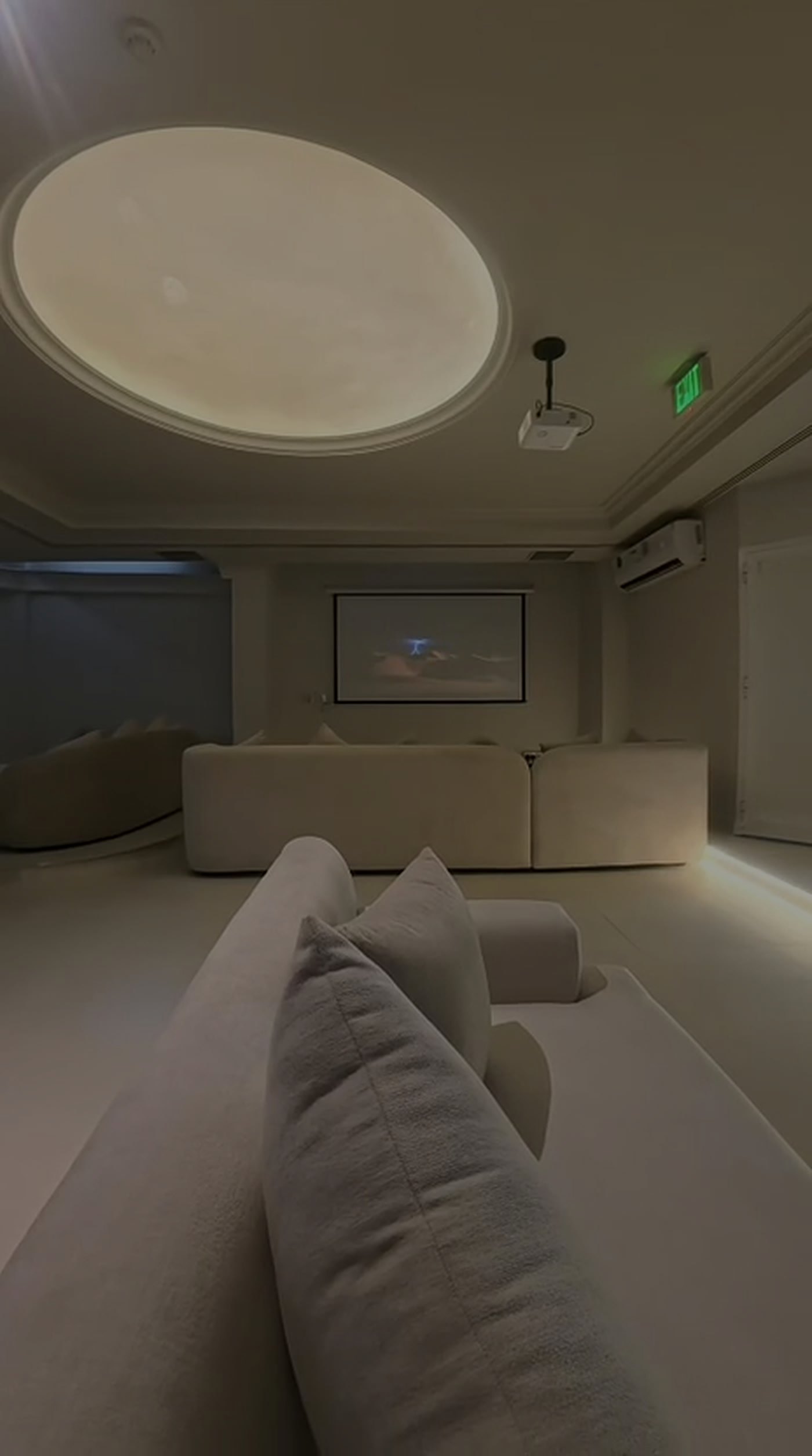 The Den at The Cauldron: a women-only basement lounge in cream light with deep sofas and a projector wall