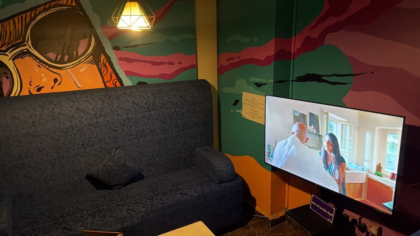A private den room with a TV and a PlayStation